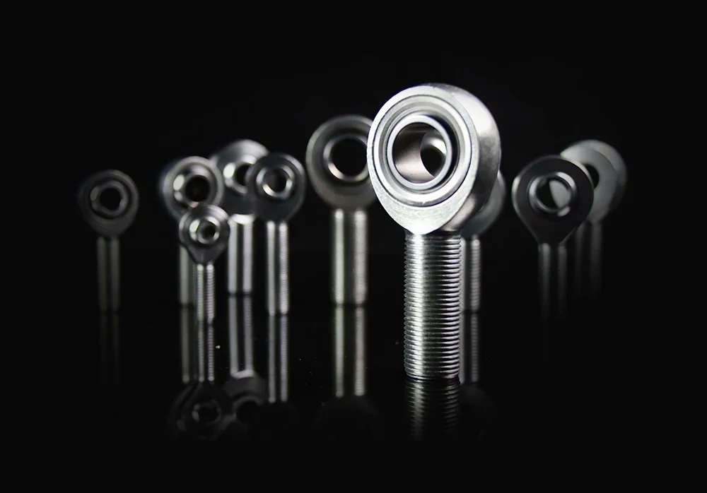 Multiple heim joints displayed in various sizes on a reflective black surface